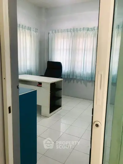 Cozy study room with desk and chair, ideal for home office setup.