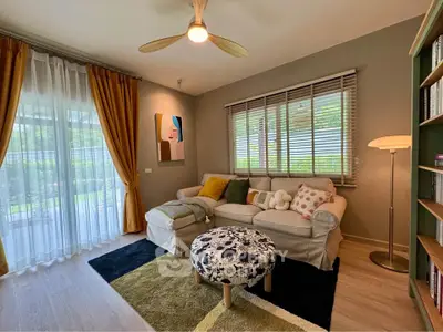 Charming living room with cozy sofa, modern decor, and natural light