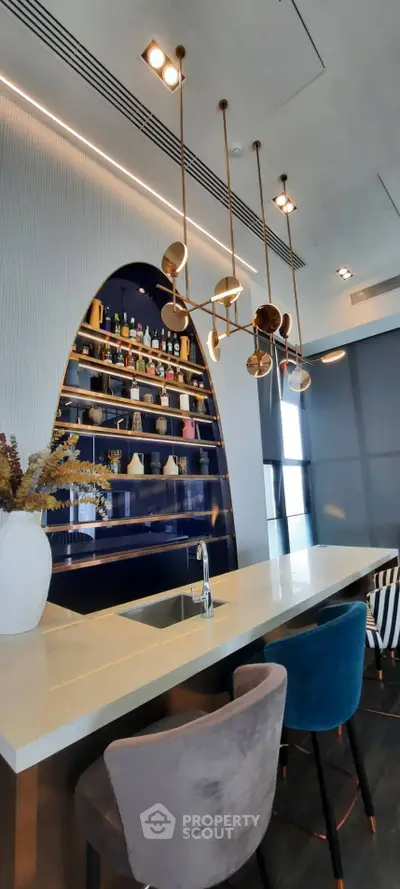 Luxurious modern kitchen with elegant bar seating and stylish lighting fixtures