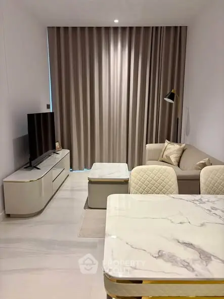 Modern living room with elegant marble dining table and cozy sofa, perfect for stylish urban living.