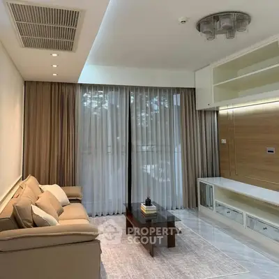 Modern living room with elegant decor and large windows