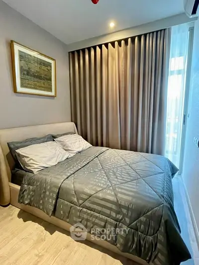 Cozy bedroom with elegant decor and natural light, featuring a plush bed and stylish curtains.