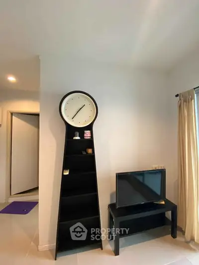 Modern living room with unique clock shelf and sleek TV stand