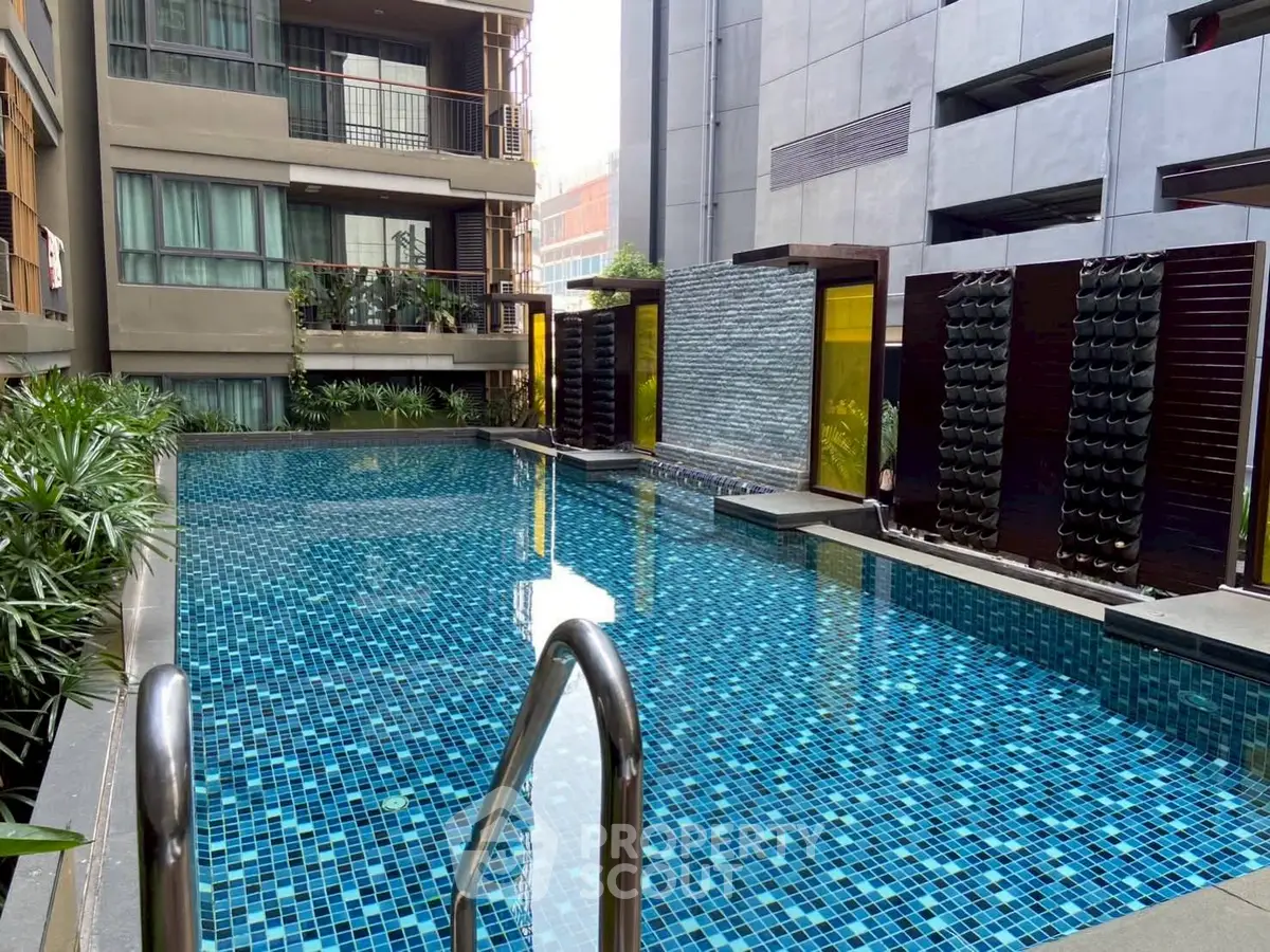 Luxurious urban pool with modern design and lush greenery