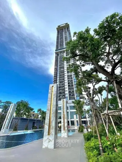 Luxurious high-rise building with modern architecture and lush landscaping