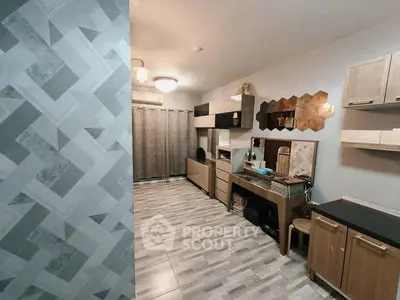 Modern living room with stylish decor and patterned wall, featuring sleek cabinetry and ambient lighting.