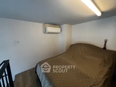 Cozy bedroom with air conditioning and modern lighting, perfect for comfortable living.