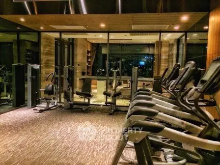 Luxurious modern gym with state-of-the-art equipment in upscale residential building.