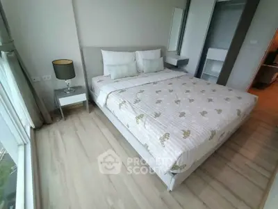 Modern bedroom with large window and stylish decor in a high-rise apartment.