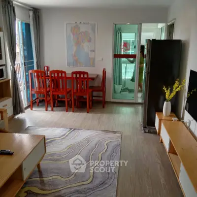 Spacious living room with modern decor and dining area, featuring a large map on the wall and a stylish rug.