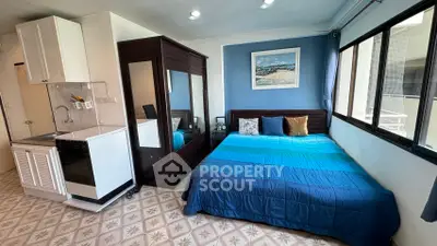 Cozy studio apartment with kitchenette and large windows