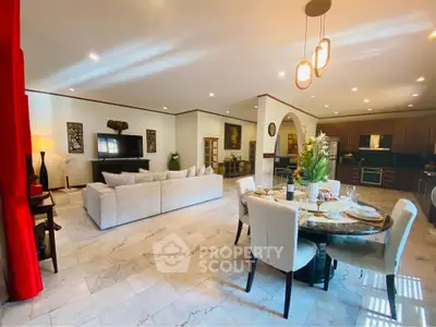 Spacious open-plan living room with elegant dining area and modern kitchen.