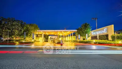 Stunning entrance of The Serene with modern architecture and lush landscaping at dusk.
