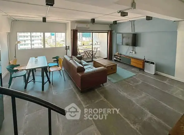 Spacious modern living room with open layout and city view balcony, perfect for urban living.