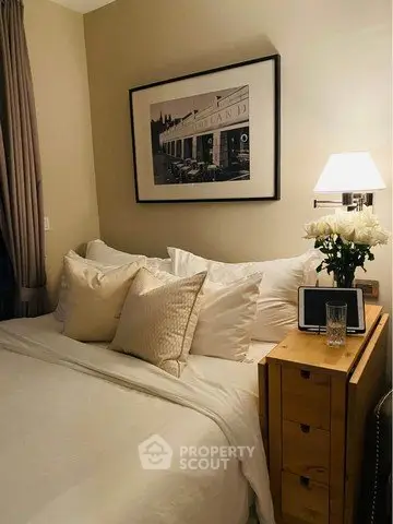 Cozy bedroom with elegant decor and soft lighting, featuring a comfortable bed and stylish nightstand.