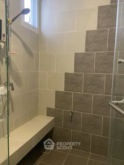 Modern bathroom with tiled shower and built-in bench seating