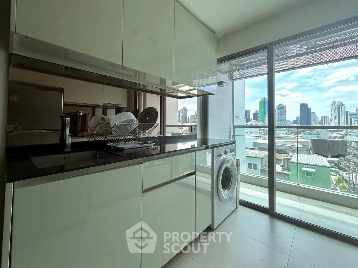 Modern kitchen with sleek cabinets and city view from large window