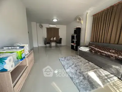 Spacious living room with modern decor and ample natural light, perfect for relaxation and entertainment.