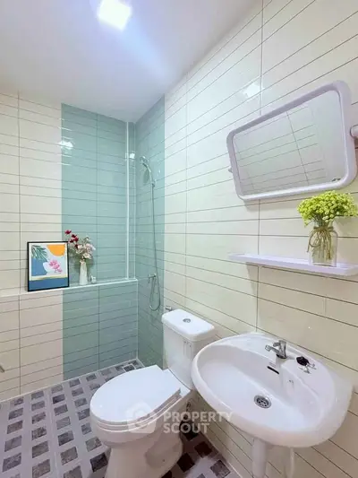 Modern bathroom with sleek tiles, shower, and stylish decor