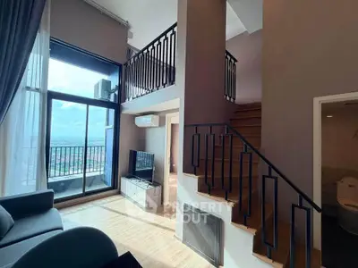 Stunning duplex living room with high ceilings and panoramic city views