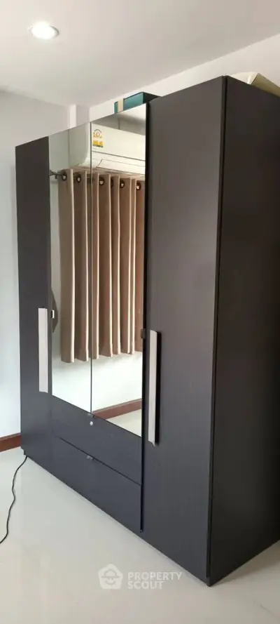 Sleek modern wardrobe with mirrored doors in a stylish bedroom setting