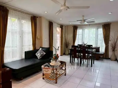 Spacious living room with elegant dining area and large windows for natural light.