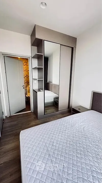 Modern bedroom with sleek wardrobe and comfortable bed in a stylish apartment.