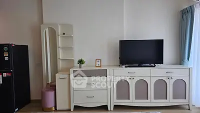Modern living room with stylish furniture and TV setup, perfect for cozy relaxation.