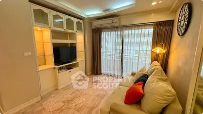 Cozy living room with modern entertainment center and large window balcony access.