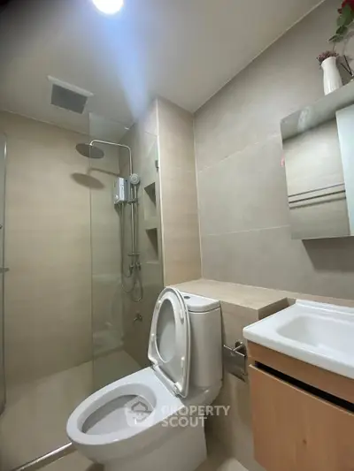 Modern bathroom with sleek fixtures and glass shower enclosure