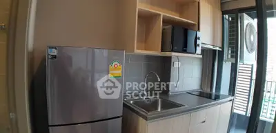 Modern kitchen with sleek appliances and open shelving in a stylish apartment.