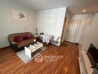 Cozy living room with modern decor and wooden flooring in a stylish apartment.