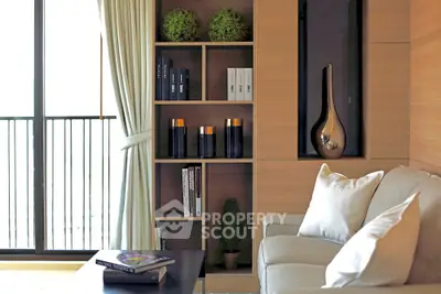 Modern living room with elegant decor and balcony view, featuring a cozy sofa and stylish shelving.