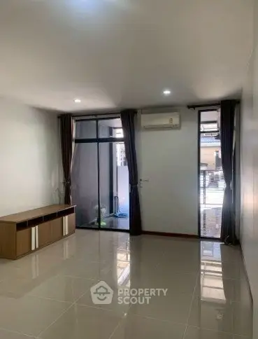 Spacious living room with modern design and large windows for natural light.