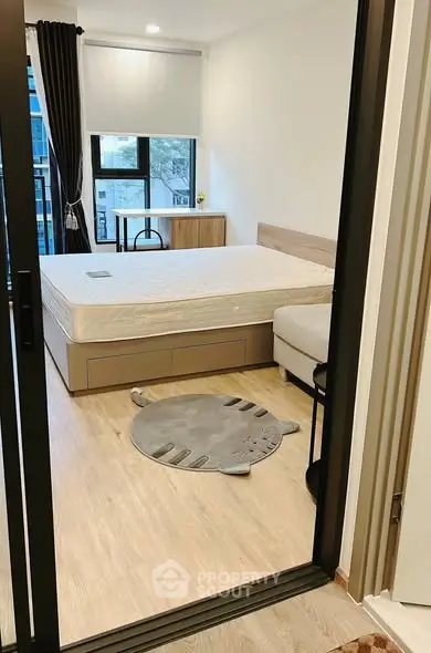 Modern bedroom with large window and stylish decor