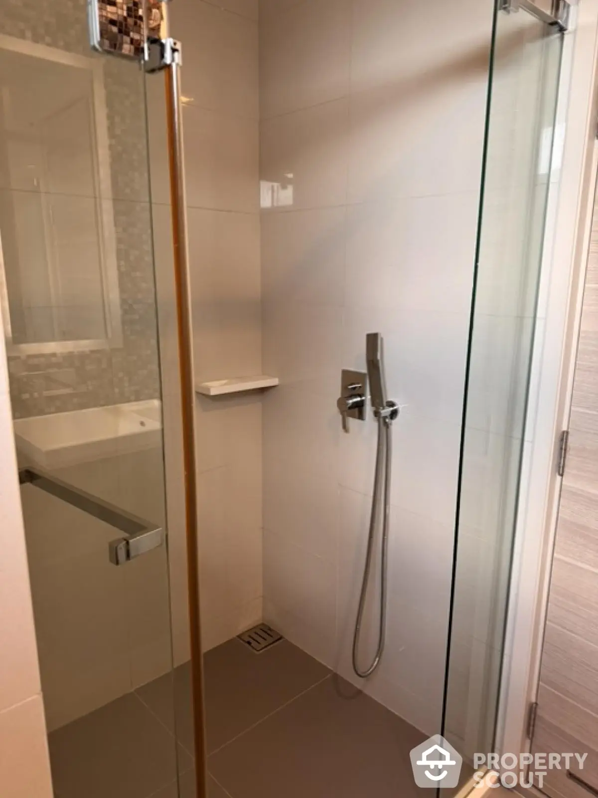 Modern bathroom with sleek glass shower enclosure and contemporary fixtures