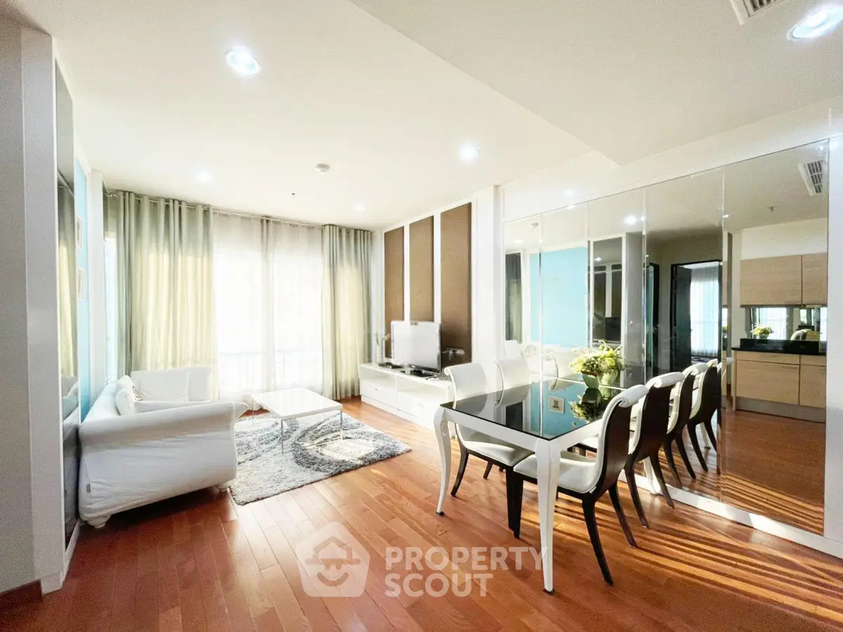 Spacious modern living room with elegant dining area and hardwood floors