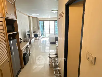 Spacious open-plan living area with modern kitchen and balcony access