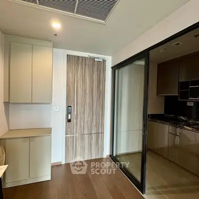 Modern apartment interior with sleek kitchen and wooden flooring