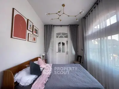 Elegant bedroom with stylish decor and large windows for natural light