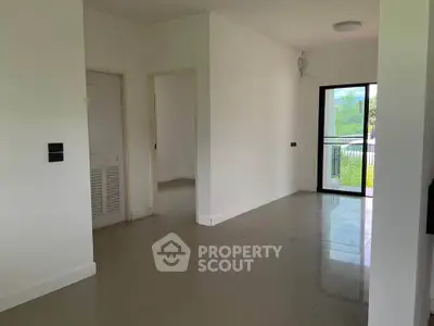 Spacious modern apartment with large windows and balcony access.