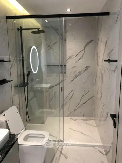Luxurious modern bathroom with marble tiles and sleek shower design