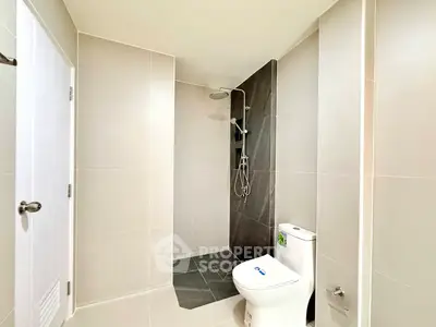 Modern bathroom with sleek shower and toilet in minimalist design