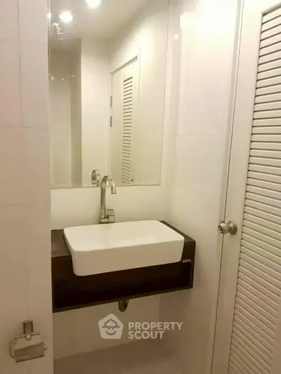 Modern bathroom with sleek sink and mirror in minimalist design