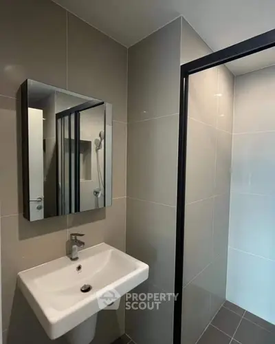 Modern bathroom with sleek sink and glass shower enclosure