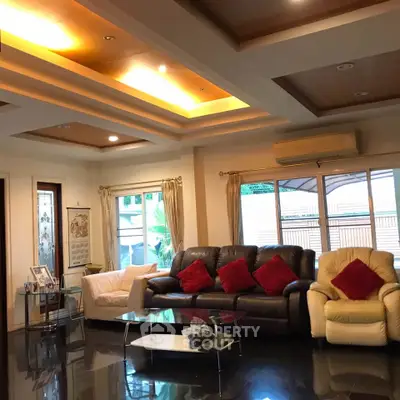 Spacious living room with modern ceiling design and cozy seating area