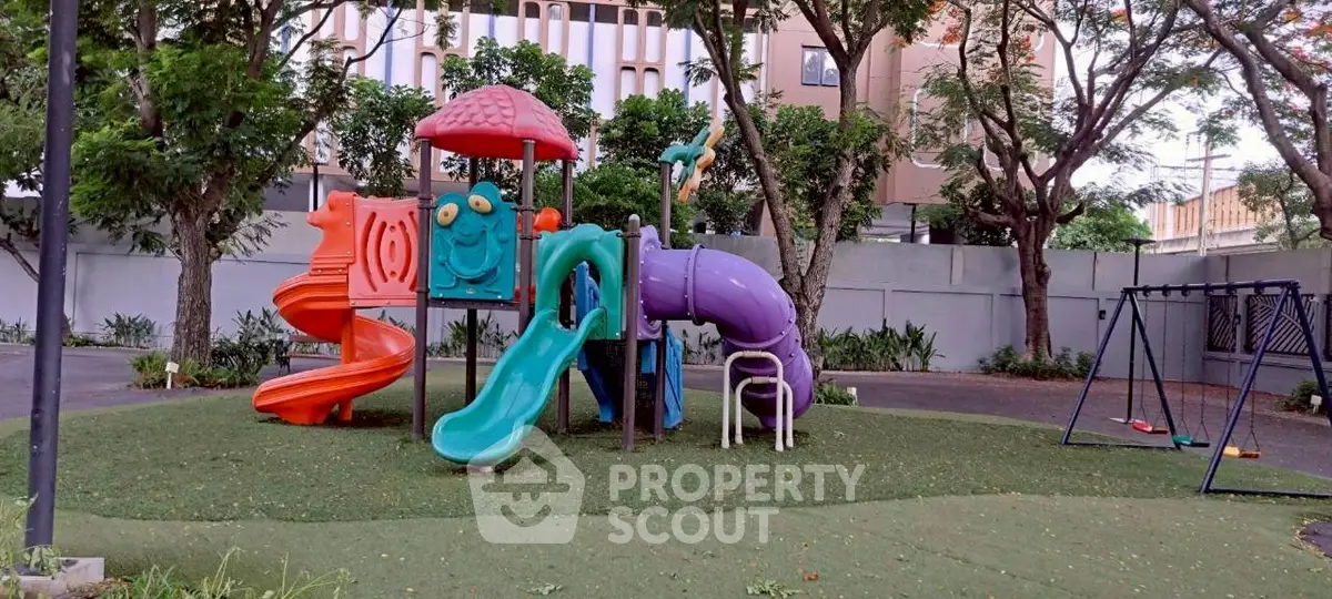 Charming residential playground with colorful slides and swings, surrounded by lush greenery, perfect for family living.