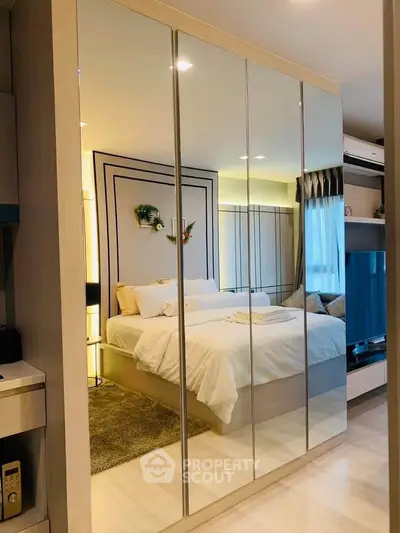 Luxurious bedroom with mirrored wardrobe and elegant decor