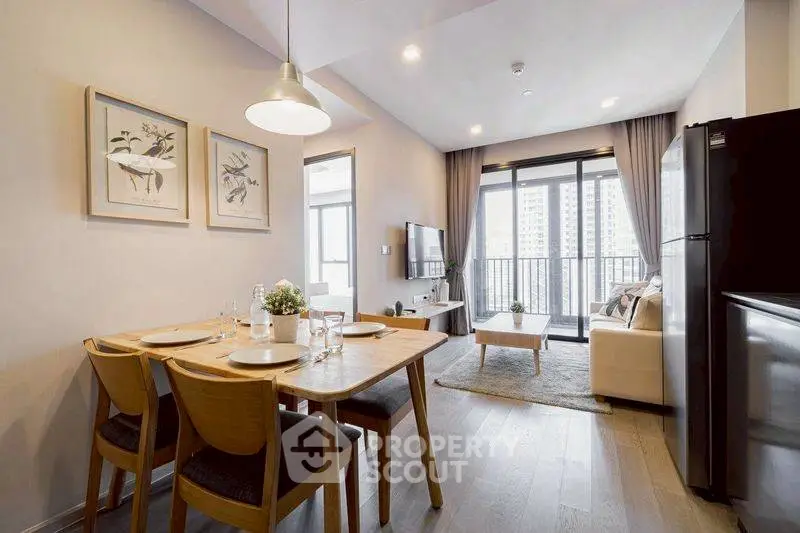 Modern open-plan living room with dining area and balcony view in a stylish apartment.