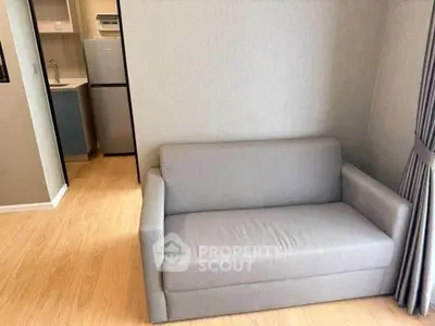 Cozy living room with modern sofa and compact kitchen area